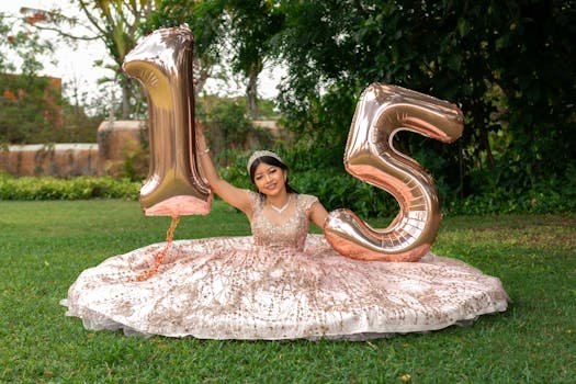 Young woman celebrating her 15th birthday in a garden with balloons and an elegant dress.